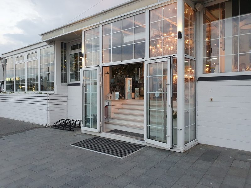 Small business storefront with glass entry doors and display windows