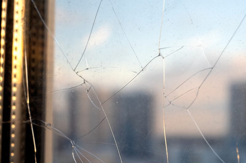 Cracked double-pane window in a home needing repair